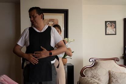 Candidate Guillermo Valencia dons a bulletproof vest prior to starting his start of the day in Morelia, Michoacán. 