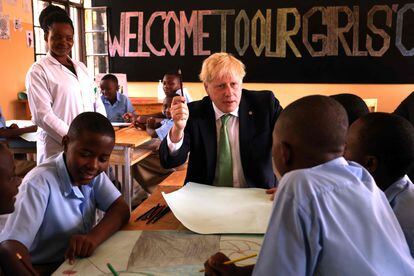 British Prime Minister Boris Johnson interacts with students during a visit to a school in Kigali, Rwanda, on Thursday on the sidelines of the Commonwealth Heads of Government Meeting (CHOGM). 