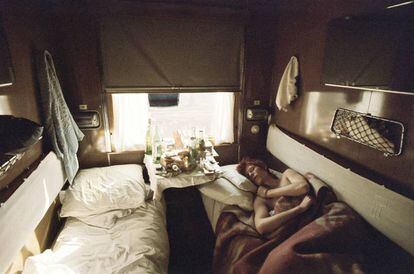 David Bowie, fotografiado en un vagón del Transiberiano por su amigo de la infancia Warren Peace, rendido a la noche mientras la luz de la mañana se cuela por la ventana.