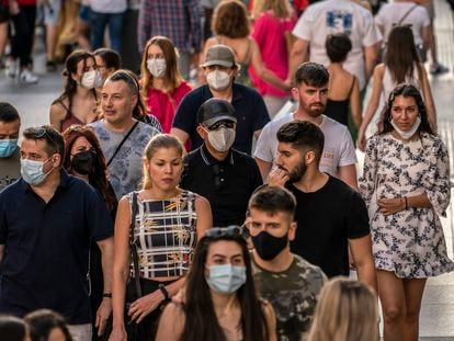 Decenas de personas, caminando por la Gran Vía en Madrid.