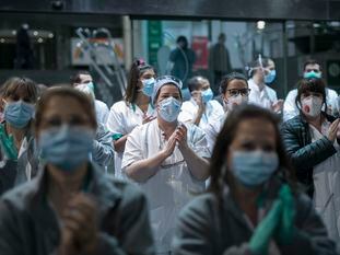 Personal sanitario del Hospital Clínic de Barcelona baja a la calle para unirse al aplauso de los vecinos, este jueves.