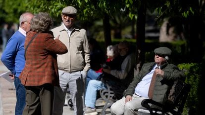 Un grupo de personas mayores conversando en un parque, en Sevilla.