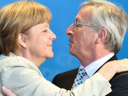 Merkel y Juncker se abrazan durante la campa&ntilde;a electoral de mayo. 