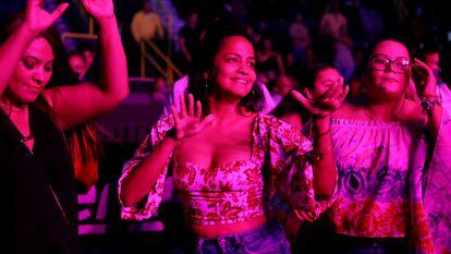 Monica Vaca, left, Ana Mendieta, and Carla Teran, all of Naples, Florida, originally of Bolivia, dance to the music of the cumbia group Los Ángeles Azules during their 40 Years anniversary tour at the Hertz Arena on Sunday, Nov. 7, 2021 in Estero, FL. Super cumbia group Los Ángeles Azules, of Iztapalapa, a borough of the Federal District of Mexico City, celebrates their 40th anniversary as a band touring the USA.