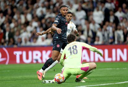Manuel Akanji watches as Real Madrid's Rodrygo scores his team's second goal against Manchester City goalkeeper Stefan Ortega. 