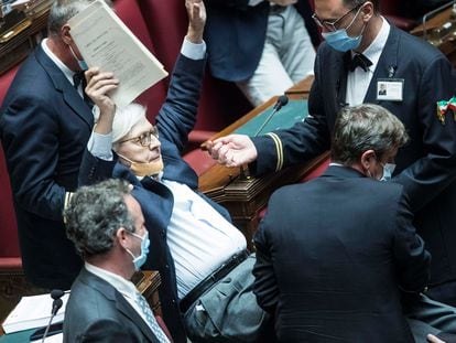 Lawmaker Vittorio Sgarbi is carried out of the Chamber of Deputies by parliamentary assistants after arguing with other lawmakers during a debate on Justice in the parliament in Rome Thursday, June 25, 2020. (Roberto Monaldo/LaPresse via AP)