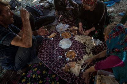 12. The yörük family gathers to eat under their tent at the end of the day.  Mehmet does not expect that his children will be able to continue migrating.  Of the three children, only the eldest, Ali, says he wants to continue caring for his animals.  Click on the image to see the complete photo gallery. 