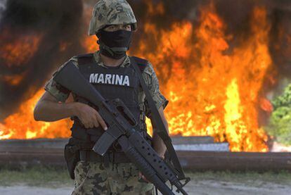 Un soldado mexicano vigila la incineración de un decomiso de cocaína en una base naval de Huatulco (Oaxaca).