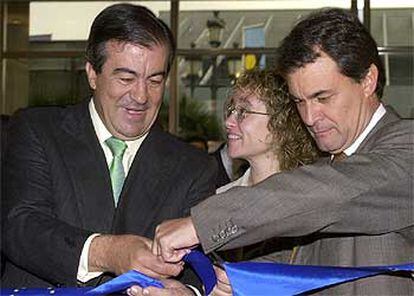 Cascos (izquierda), acompañado de Artur Mas, y de la delegada del Gobiern, Susana Bouis, cortan la cinta inaugural del salón inmobiliario.
