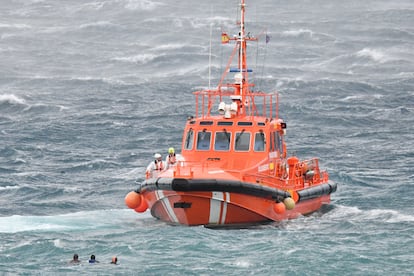 Una lancha de Salvamento Marítimo socorre a tres migrantes que nadaban en la bahía Norte, cerca del paso de Benzú, en Ceuta, esta mañana.