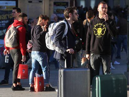 Turistas esperan cerca de una vivienda de alquiler turístico.