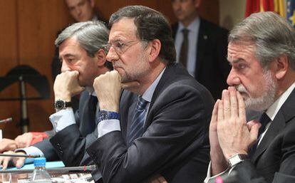 El presidente del PP, Mariano Rajoy, entre los exministros Ángel Acebes y Jaime Mayor Oreja.