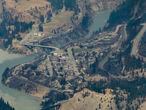 In this aerial photo taken from a helicopter, structures destroyed by a wildfire are seen in Lytton, British Columbia, on Thursday, July 1, 2021. A wildfire that forced people to flee a small town in British Columbia that had set record high temperatures for Canada on three consecutive days burned out of control Thursday as relatives desperately sought information on evacuees. (Darryl Dyck/The Canadian Press via AP)