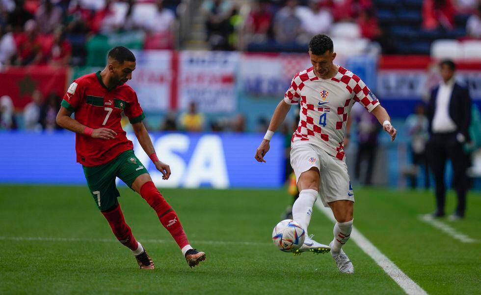 Croatia's Ivan Perisic, right, vies for the ball with Morocco's Hakim Ziyech during the World Cup group F soccer match between Morocco and Croatia, at the Al Bayt Stadium in Al Khor , Qatar, Wednesday, Nov. 23, 2022. (AP Photo/Thanassis Stavrakis)