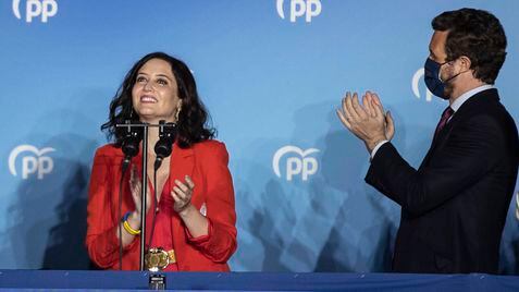 Conservative Madrid regional president Isabel Diaz Ayuso, left, and Popular party leader Pablo Casasdo celebrate election results outside the popular party headquarters in Madrid, Spain, Tuesday, May 4, 2021. Madrid residents voted in droves for a new regional assembly in an election that tests the depths of resistance to virus lockdown measures and the divide between left-wing and right-wing parties. Regional President Isabel Díaz Ayuso, who called the early election by dissolving her center-right coalition, had set off to broaden her power base and open up to an alliance with the far-right. (AP Photo/Bernat Armangue)