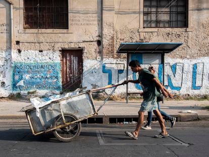 Dos hombres recogen cajas de cartón de la basura para reciclar en la ciudad argentina de Rosario.