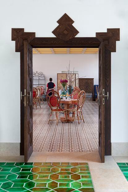 El acceso al comedor, con un pavimento 'vermelho' realizado por encargo en la fábrica de azulejos de Azeitão que Portugal produce desde el siglo XVI. La Maison Gatti de París firma las sillas bistró de un ratán colorista trenzado con destreza centenaria.