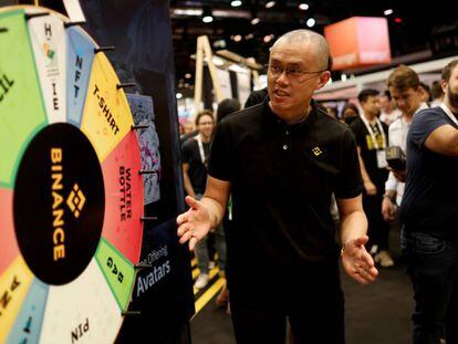 Changpeng Zhao, fundador y CEO de Binance, la mayor plataforma cripto del mundo, junto a una ruleta de premios.