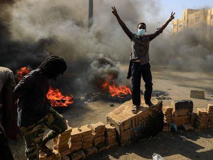Manifestantes sudaneses queman neumáticos para bloquear una carretera de Jartum.