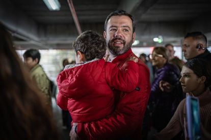 Carlos Fernando Galán, carries his son at his voting station, in Bogotá, on October 29, 2023.