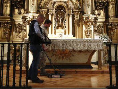 Dos operarios aplican el georradar sobre el piso de la iglesia de Las Trinitarias cuyo subsuelo aloja la cripta abierta ayer.