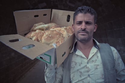 A young Yemeni man sells bread to make ends meet.