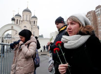 A woman holds red carnations in her hand outside the Moscow church this Friday. 
