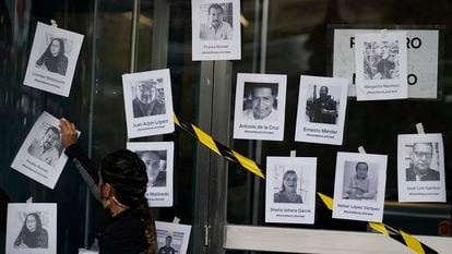 A man puts up photos of slain journalists after the murder of journalist Fredid Roman during a vigil to protest the crime, outside Mexico's Attorney General's office in Mexico City, Wednesday, Aug. 24, 2022. Roman was the 15th media worker killed so far this year in Mexico, where it is now considered the most dangerous country for reporters outside a war zone. (AP Photo/Eduardo Verdugo)