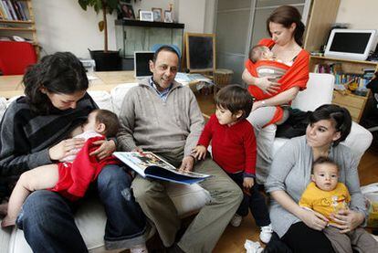 El ginecólogo Emilio Santos, con su hijo y un grupo de madres y niños que nacieron en casa.