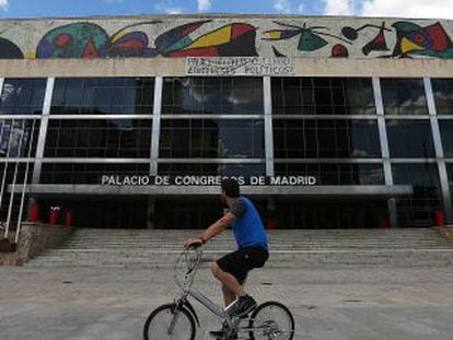 Un ciclista pasa por delante del Palacio de Congresos.