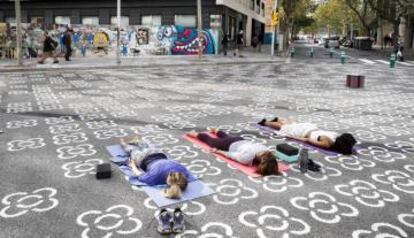 Vecinas de Poblenou practican yoga en una de las intersecciones de la 'supermanzana'. |