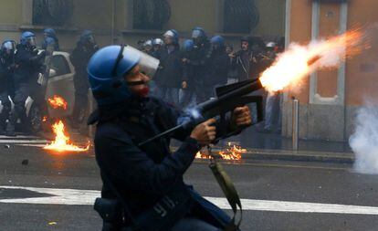 Un policía italiano lanza un lacrimógeno durante los disturbios de este viernes en una manifestación contra la inauguración de la Exposición Universal de Milán 2015.