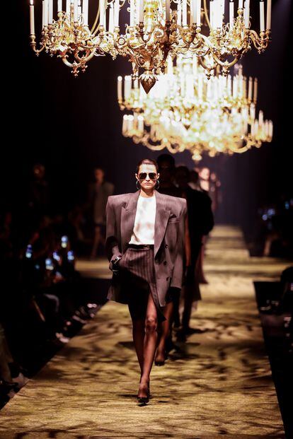 Marked shoulder pads under chandeliers at the Intercontinental hotel in Paris, the keys to Anthony Vaccarello's collection for Saint Laurent at his Paris fashion week show on February 28, 2023.
