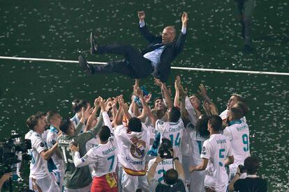 Los jugadores del Real Madrid mantean al entrenador Zinedine Zidane durante la celebración del triunfo en la Champion League en el estadio Santiago Bernabéu.
