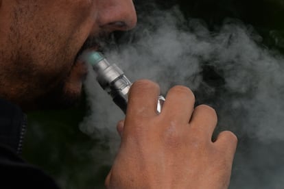 In a file photo, a man uses his electronic cigarette.