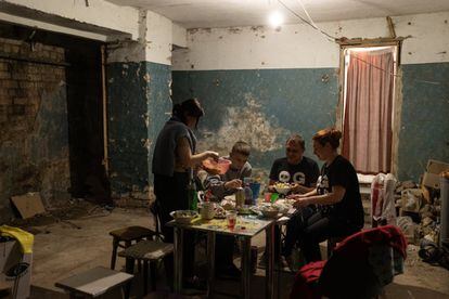 Los pocos vecinos que quedan en un bloque de pisos en Járkov, en el noreste de Ucrania, cenaban el viernes en el sótano del edificio, utilizado como refugio donde pasas las noches.