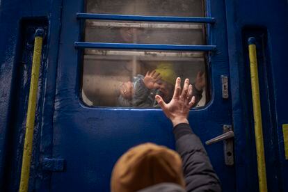 A man says goodbye to his wife and son, about to leave on a train to Lviv from the kyiv station, on March 3. 