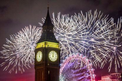 Los fuegos artificiales iluminan el cielo sobre el London Eye y el Big Ben, en el centro de Londres.