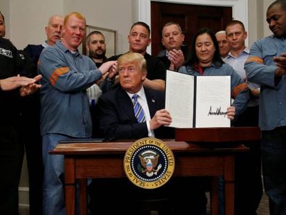 Trump firma los aranceles rodeado de trabajadores del acero y el aluminio.