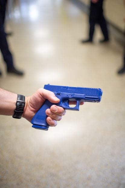 Un policía muestra en el instituto de Greenport la réplica de una pistola. 