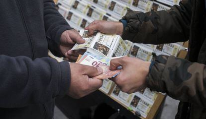 Un joven vendiendo lotería en la calle del Carmen (Madrid).