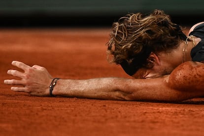 Alexander Zverev, tumbado en la tierra tras lesionarse.