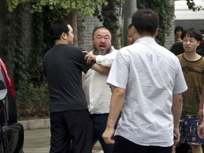 El artista chino Ai Weiwei se enfrenta a la policía a las puertas de su casa en Pekín.