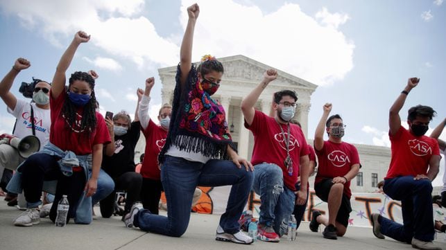 DACA recipients and their supporters kneel in support of the Black Lives Matter movement, chanting "Say their Names" and the names of Breonna Taylor and George Floyd, as they celebrate outside the U.S. Supreme Court after the court ruled in a 5-4 vote that U.S. President Donald Trump's 2017 move to rescind the Deferred Action for Childhood Arrivals (DACA) program, created in 2012 by his Democratic predecessor Barack Obama, was unlawful, in Washington, U.S. June 18, 2020.   REUTERS/Jonathan Ernst