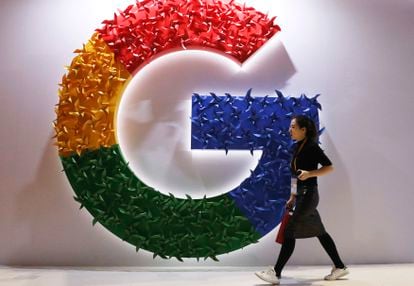 A woman walks past a Google logo at an import fair in Shanghai.