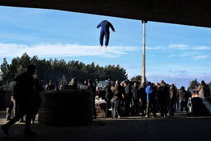 An effigy of a farmer in overalls hangs from a road overpass at the Nimes-Ouest exit of the A9 motorway, near Nimes, southern France.