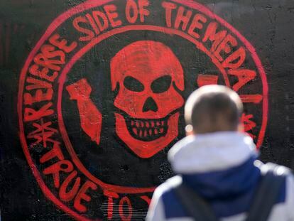 A boy walks by a repainted mural depicting the logo of Russia's Wagner Group on a wall in Belgrade, Serbia, Thursday, Jan. 19, 2023. (AP Photo/Darko Vojinovic)