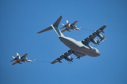 Un avión Airbus A400M reabastece de combustible a dos cazas F-18 durante el desfile aéreo con motivo de la Fiesta Nacional del 12 de octubre en Madrid.
