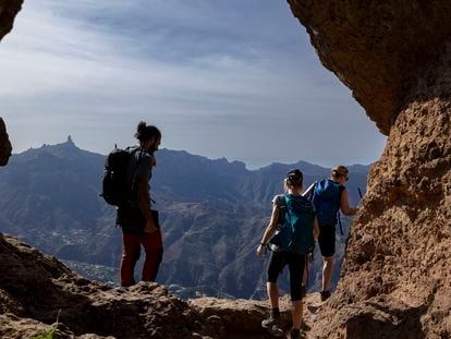 Senderistas en el yacimiento arqueológico Cuevas de Caballeros, en la isla de Gran Canaria.