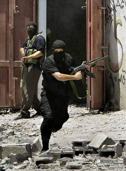 Un miliciano de Hamás corre para esquivar los disparos ayer en Gaza.